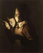 Bild:Boy blowing into a lamp