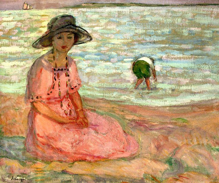 A girl in a pink robe by the sea
