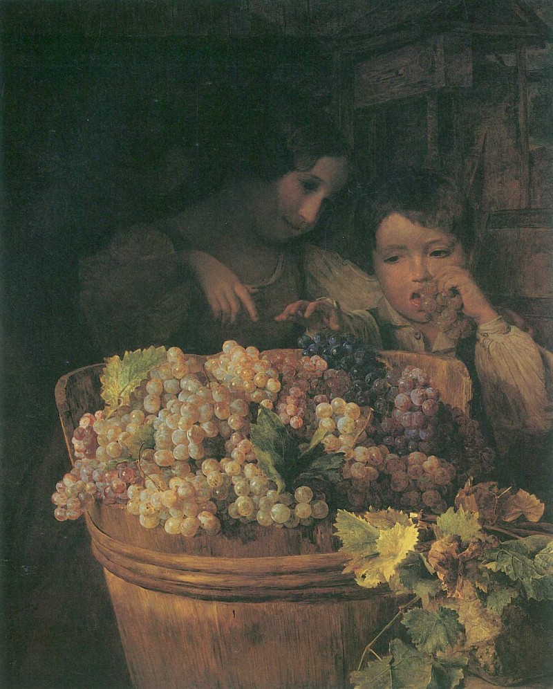Kinder bei einer Butte mit Trauben